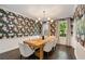 Elegant dining room with decorative wallpaper, modern lighting, and a stylish table set for dining at 615 Pinetree Dr, Decatur, GA 30030