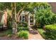 Charming brick townhome featuring a welcoming brick pathway and lush landscaping leading to the front door at 615 Pinetree Dr, Decatur, GA 30030