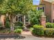 Lovely brick townhome with a brick walkway, mature tree and lush bushes leading to a decorated door at 615 Pinetree Dr, Decatur, GA 30030