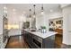 Bright kitchen with white cabinets, quartz countertops, stainless steel appliances, and view into a living area at 615 Pinetree Dr, Decatur, GA 30030
