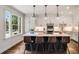 Contemporary kitchen with white cabinetry, an island with bar seating, and natural light from a large window at 615 Pinetree Dr, Decatur, GA 30030