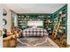 Stylish office showcasing a murphy bed flanked by bookshelves, a cozy rug, and a leather chair at 615 Pinetree Dr, Decatur, GA 30030