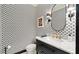Stylish powder room with patterned wallpaper, modern fixtures, a marble countertop, and sleek design at 615 Pinetree Dr, Decatur, GA 30030