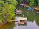 Aerial view of lake featuring covered docks, lush trees, and ample space for boating and recreation at 921 Oak Dr, Woodstock, GA 30189