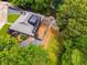 Stunning aerial view of home with a large deck and a rooftop deck, surrounded by lush greenery at 921 Oak Dr, Woodstock, GA 30189
