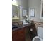 Cozy half-bathroom featuring unique stone flooring and wainscoting, a vanity and decorative accents at 921 Oak Dr, Woodstock, GA 30189