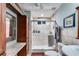 Well-lit bathroom with stone shower, neutral color scheme and ample storage at 921 Oak Dr, Woodstock, GA 30189