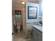 Bright bathroom with modern fixtures, stone accents, and a shower with a curtain at 921 Oak Dr, Woodstock, GA 30189