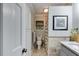 Cozy bathroom featuring a toilet, white cabinets, framed art, and a window providing natural light at 921 Oak Dr, Woodstock, GA 30189