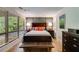 Cozy bedroom with large window, hardwood floors, and contemporary furnishings at 921 Oak Dr, Woodstock, GA 30189
