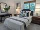 Comfortable bedroom with a plush bed, stylish decor, and natural light from the window at 921 Oak Dr, Woodstock, GA 30189