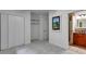 Empty bedroom with white walls, gray carpet, adjacent closet, and bathroom entrance at 921 Oak Dr, Woodstock, GA 30189