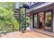 Outdoor deck with glass railing, spiral staircase and backyard entrance at 921 Oak Dr, Woodstock, GA 30189