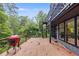 Wooden deck featuring outdoor seating, a grill, a spiral staircase, and glass railings at 921 Oak Dr, Woodstock, GA 30189