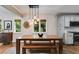 Bright dining room featuring a wooden table with bench seating and modern pendant lighting at 921 Oak Dr, Woodstock, GA 30189