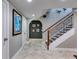 Hallway with decorative archway, a staircase, tiled flooring, and neutral paint at 921 Oak Dr, Woodstock, GA 30189