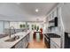 Modern kitchen open to dining area featuring stainless appliances and stone countertops at 921 Oak Dr, Woodstock, GA 30189