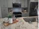 Modern kitchen featuring granite countertops, stainless steel appliances, and neutral colors at 921 Oak Dr, Woodstock, GA 30189
