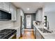 Stylish kitchen featuring stainless steel appliances, granite counters and gray cabinets at 921 Oak Dr, Woodstock, GA 30189
