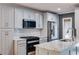 Bright kitchen featuring custom cabinets, granite countertops, stainless appliances, and a stylish backsplash at 921 Oak Dr, Woodstock, GA 30189