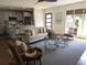 Bright living room featuring a sofa, stylish coffee tables, a ceiling fan, and hardwood floors at 921 Oak Dr, Woodstock, GA 30189