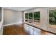 Spacious living room with neutral paint and large windows overlooking mature trees at 921 Oak Dr, Woodstock, GA 30189