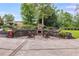 Outdoor patio with stone fireplace, pavers, retaining wall, and manicured landscaping for entertaining at 921 Oak Dr, Woodstock, GA 30189