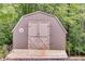 Backyard shed with double doors and wooden base at 921 Oak Dr, Woodstock, GA 30189
