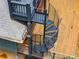 Close up view of a black spiral staircase connecting wooden rooftop deck areas at 921 Oak Dr, Woodstock, GA 30189