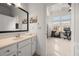 Bright bathroom featuring a wide mirror over the sink and entry to study area at 1258 Dekalb Ne Ave # 112, Atlanta, GA 30307