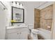 Bathroom with a white vanity, toilet, and shower/tub combination with tiled walls at 1258 Dekalb Ne Ave # 112, Atlanta, GA 30307