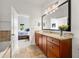 Bathroom with granite countertop, dark cabinets, and tub with tile surround at 1258 Dekalb Ne Ave # 112, Atlanta, GA 30307