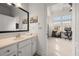Bathroom featuring a large mirror over a white vanity, with a view into a bright office space at 1258 Dekalb Ne Ave # 112, Atlanta, GA 30307