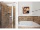 Bathroom with a tiled walk-in shower and a separate soaking tub perfect for relaxation at 1258 Dekalb Ne Ave # 112, Atlanta, GA 30307