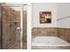 A tiled walk-in shower and separate soaking tub create a spa-like experience at 1258 Dekalb Ne Ave # 112, Atlanta, GA 30307