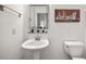 Modern half bath with pedestal sink and a unique wall art, offering a blend of style and functionality at 1258 Dekalb Ne Ave # 112, Atlanta, GA 30307