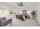 Well lit primary bedroom with a ceiling fan, a cozy chair and large window at 1258 Dekalb Ne Ave # 112, Atlanta, GA 30307
