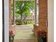 Home entrance features brick columns, green space, and flower pots at 1258 Dekalb Ne Ave # 112, Atlanta, GA 30307