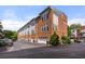 Exterior elevation of a well maintained brick building with garage doors at 1258 Dekalb Ne Ave # 112, Atlanta, GA 30307