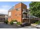 View of the brick exterior featuring balconies, multiple windows, and well-maintained landscaping at 1258 Dekalb Ne Ave # 112, Atlanta, GA 30307