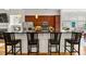 Open kitchen featuring granite countertops, stainless steel appliances, and a breakfast bar with modern bar stools at 1258 Dekalb Ne Ave # 112, Atlanta, GA 30307