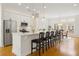 Open-concept kitchen with stainless steel appliances, white cabinets, countertop dining, and eat-in dining area at 1258 Dekalb Ne Ave # 112, Atlanta, GA 30307