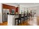 Bright kitchen with wooden cabinets, stainless steel appliances, and island with barstool seating at 1258 Dekalb Ne Ave # 112, Atlanta, GA 30307