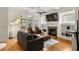 Cozy living room with a fireplace, built-in shelving, hardwood floors, and access to an outdoor balcony at 1258 Dekalb Ne Ave # 112, Atlanta, GA 30307