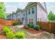 Landscaped backyard area with stone walkway and wood fence for privacy, a small seating area, and beautiful greenery at 2021 Towneship Trl, Roswell, GA 30075