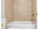 Clean white bathtub and shower with light brown tile surround at 2021 Towneship Trl, Roswell, GA 30075