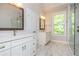 Bathroom with a double vanity, glass shower and marble floors at 2021 Towneship Trl, Roswell, GA 30075