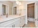 Bright bathroom featuring double sinks, marble countertops, and a tile shower at 2021 Towneship Trl, Roswell, GA 30075