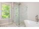 Bathroom with a glass shower, soaking tub and white marble floor at 2021 Towneship Trl, Roswell, GA 30075