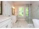 Large primary bathroom with double vanity, glass shower and marble floors at 2021 Towneship Trl, Roswell, GA 30075